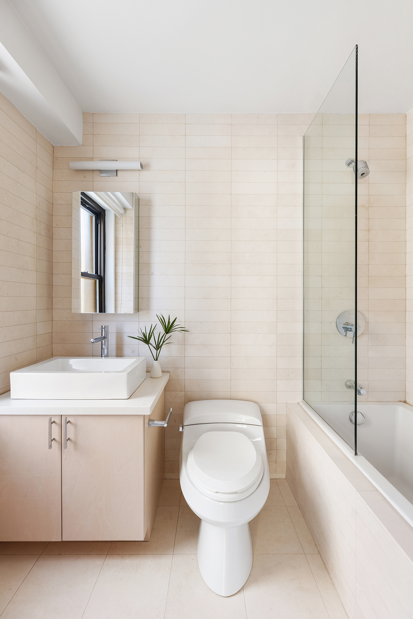 1065 Park Avenue, Unit 5BC Manhattan, NY 10128 - Photo 9 of 16 a bathroom with a sink a toilet and shower