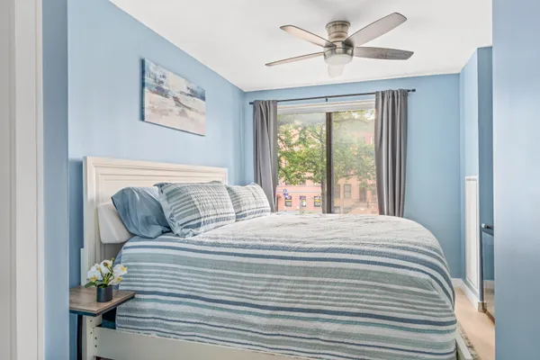 a bedroom with a bed and a chandelier