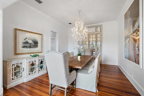 a view of a dining room with furniture wooden floor and chandelier