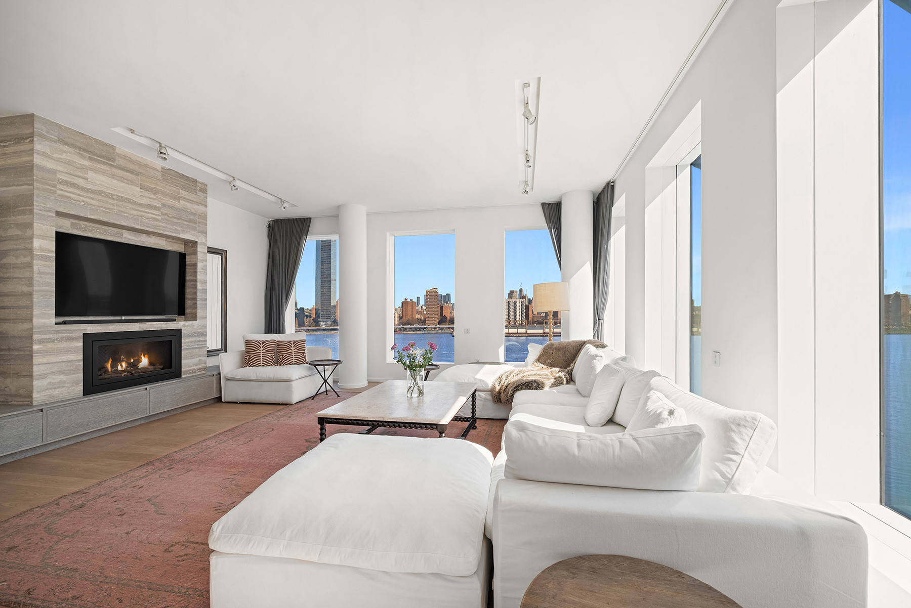 1 John Street, Unit 9D Brooklyn, NY 11201 - Photo 2 of 20 a living room with furniture a flat screen tv and a fireplace