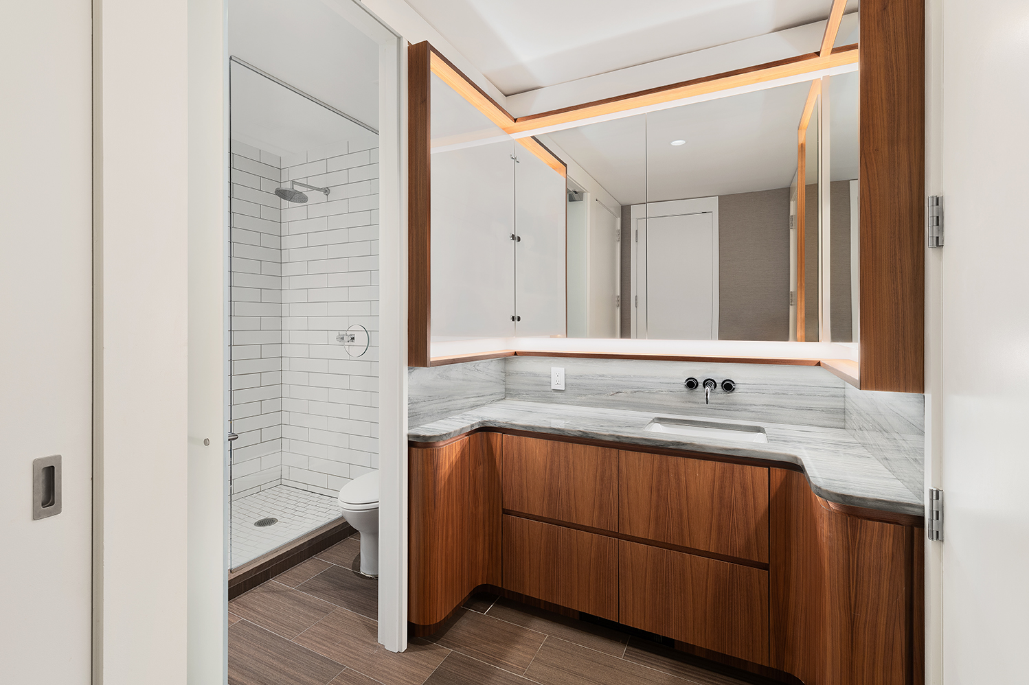 15 William Street, Unit 22H Manhattan, NY 10005 - Photo 6 of 20 a bathroom with a sink and a mirror