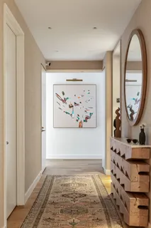 a bedroom with a bed and large windows