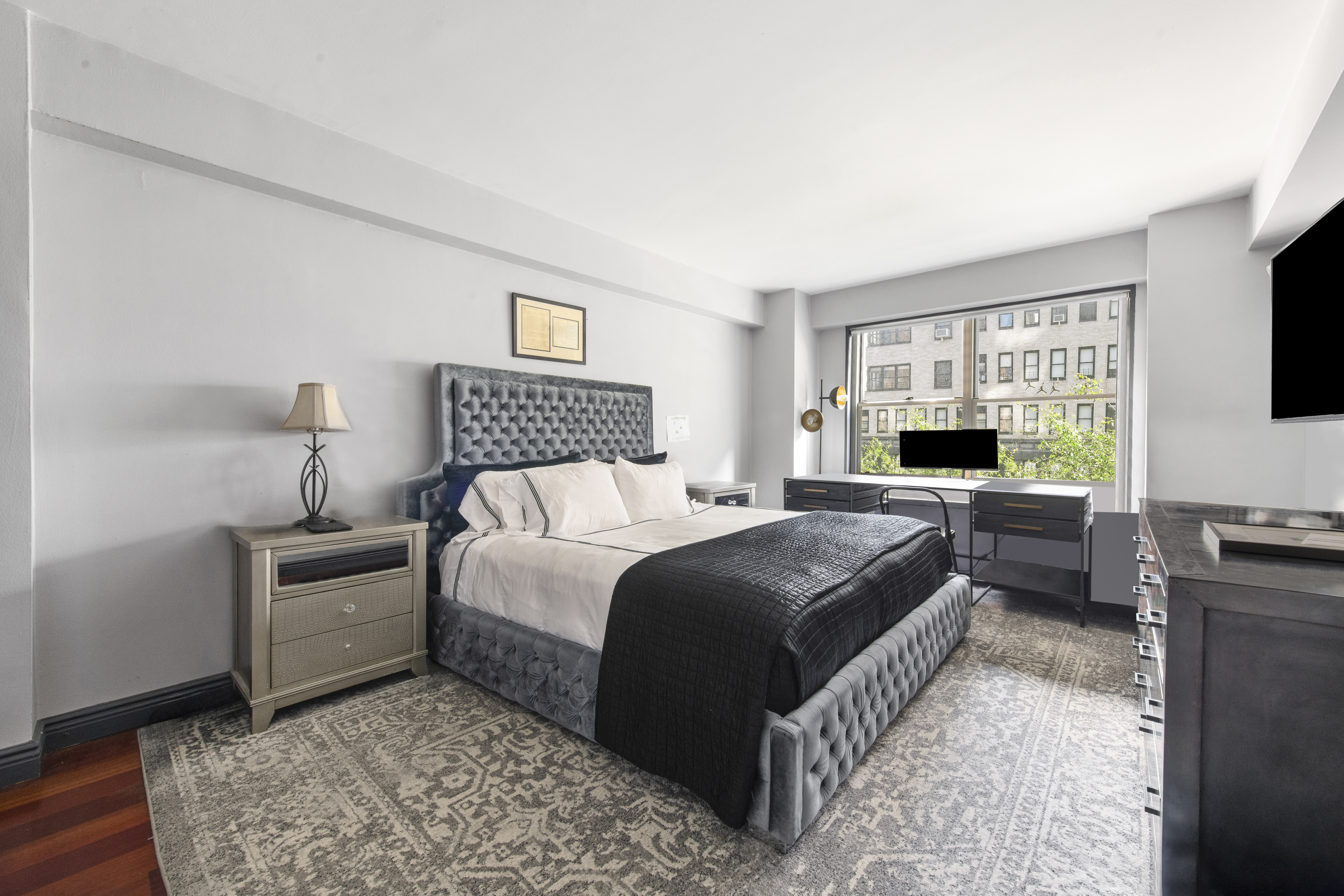 400 East 56th Street, Unit 3D Manhattan, NY 10022 - Photo 8 of 21 a bedroom with a bed and a flat screen tv