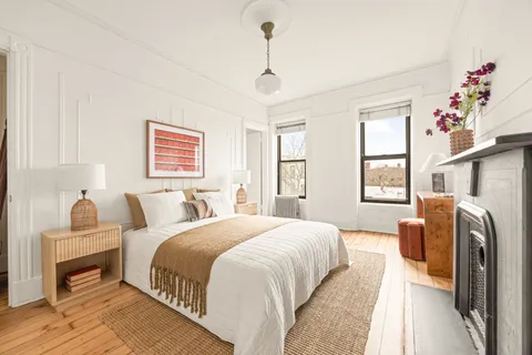 a bedroom with bed and a window