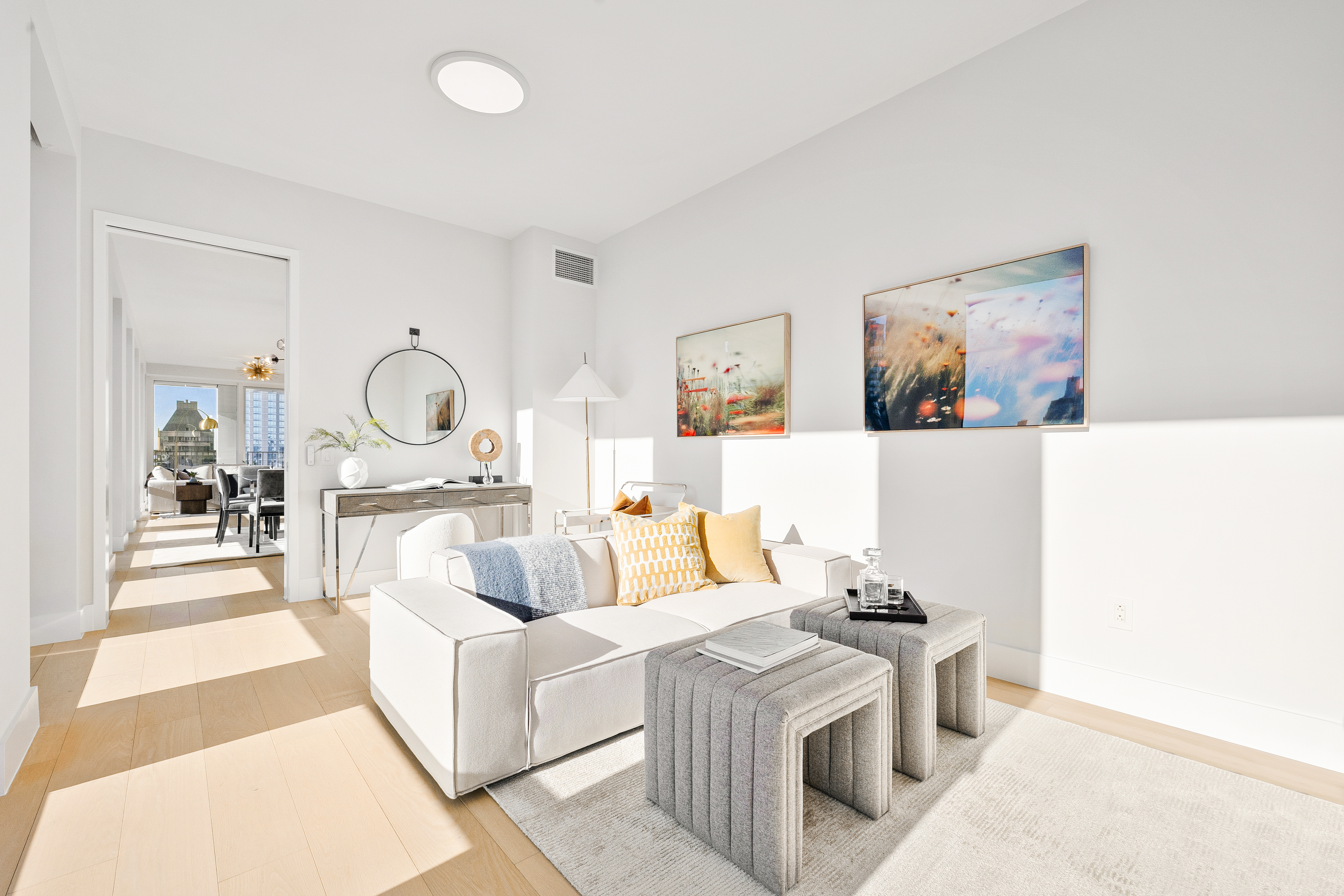 15 West 61st Street, Unit PH1C Manhattan, NY 10023 - Photo 10 of 26 a living room with furniture and a mirror