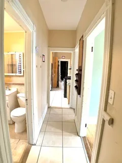 a bathroom with a sink and mirror with toilet