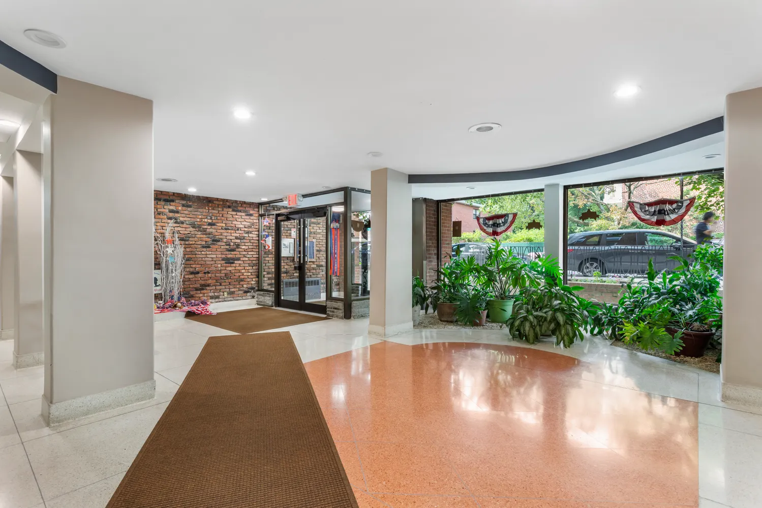 a very nice looking room with a large window and potted plants
