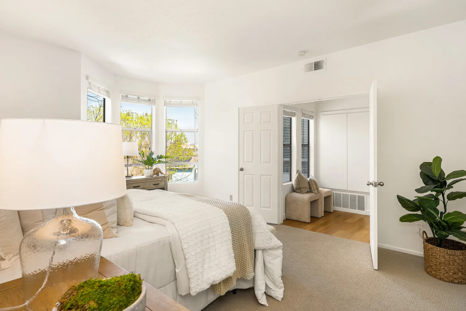 a bedroom with a bed and a lamp