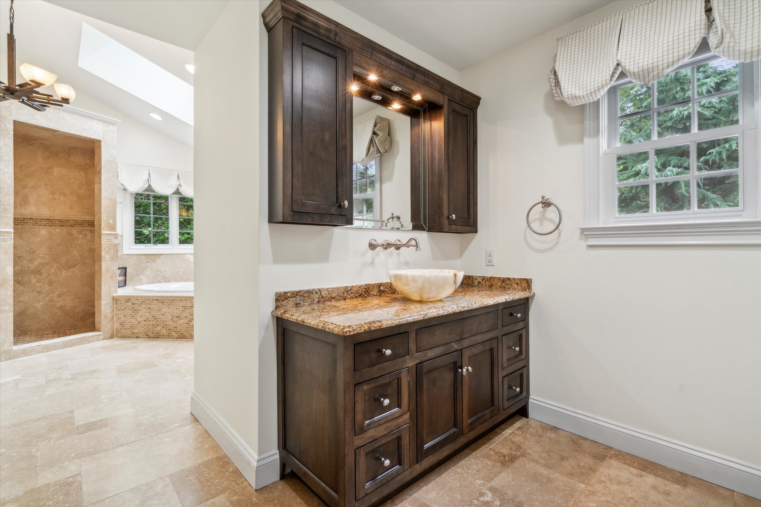 145 Biddulph Road Wayne, PA 19087 - Photo 23 of 39 a bathroom with a granite countertop sink a large mirror and a window