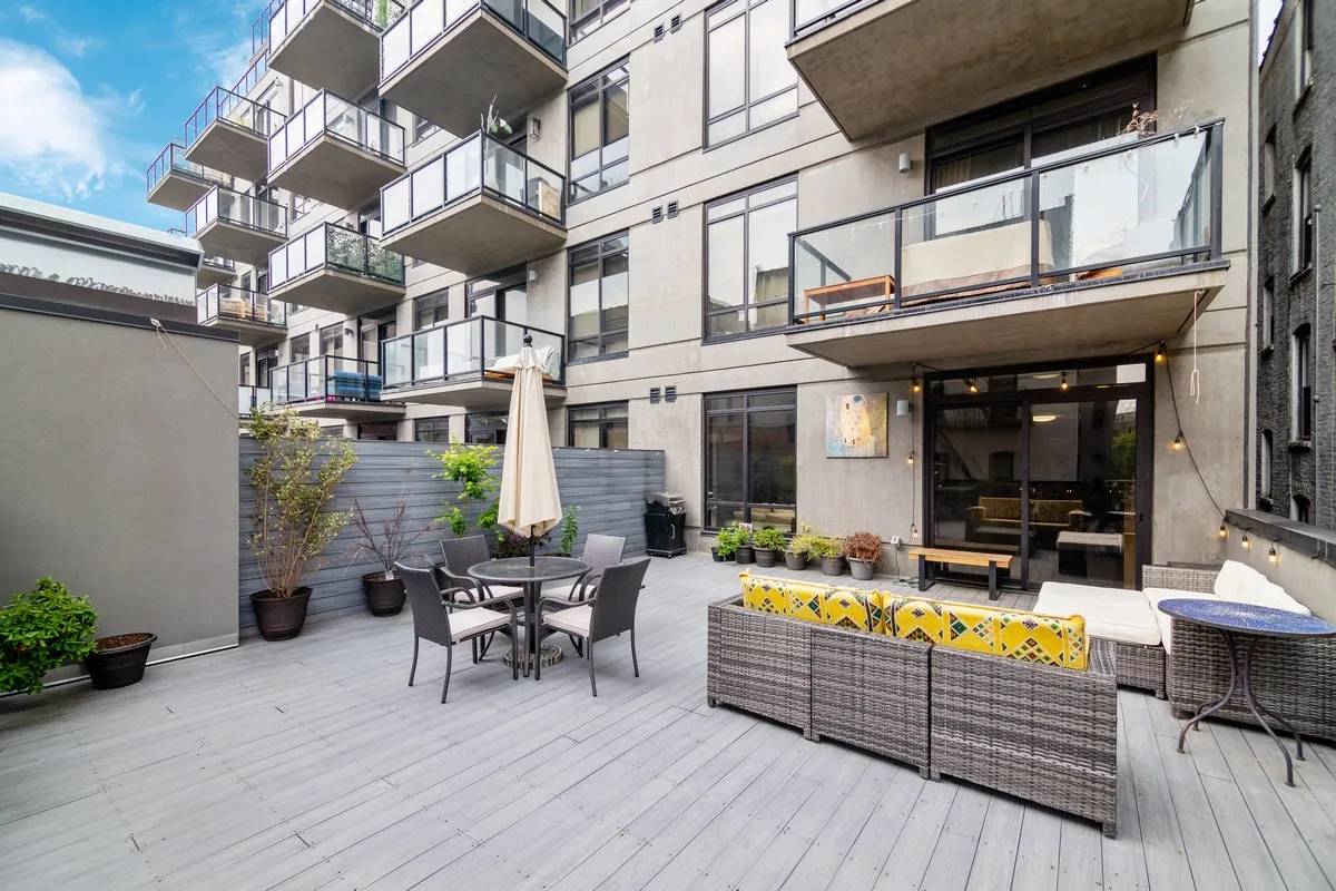 a view of a building with sitting area and furniture