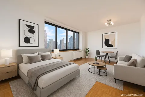 a bedroom with furniture and a large window