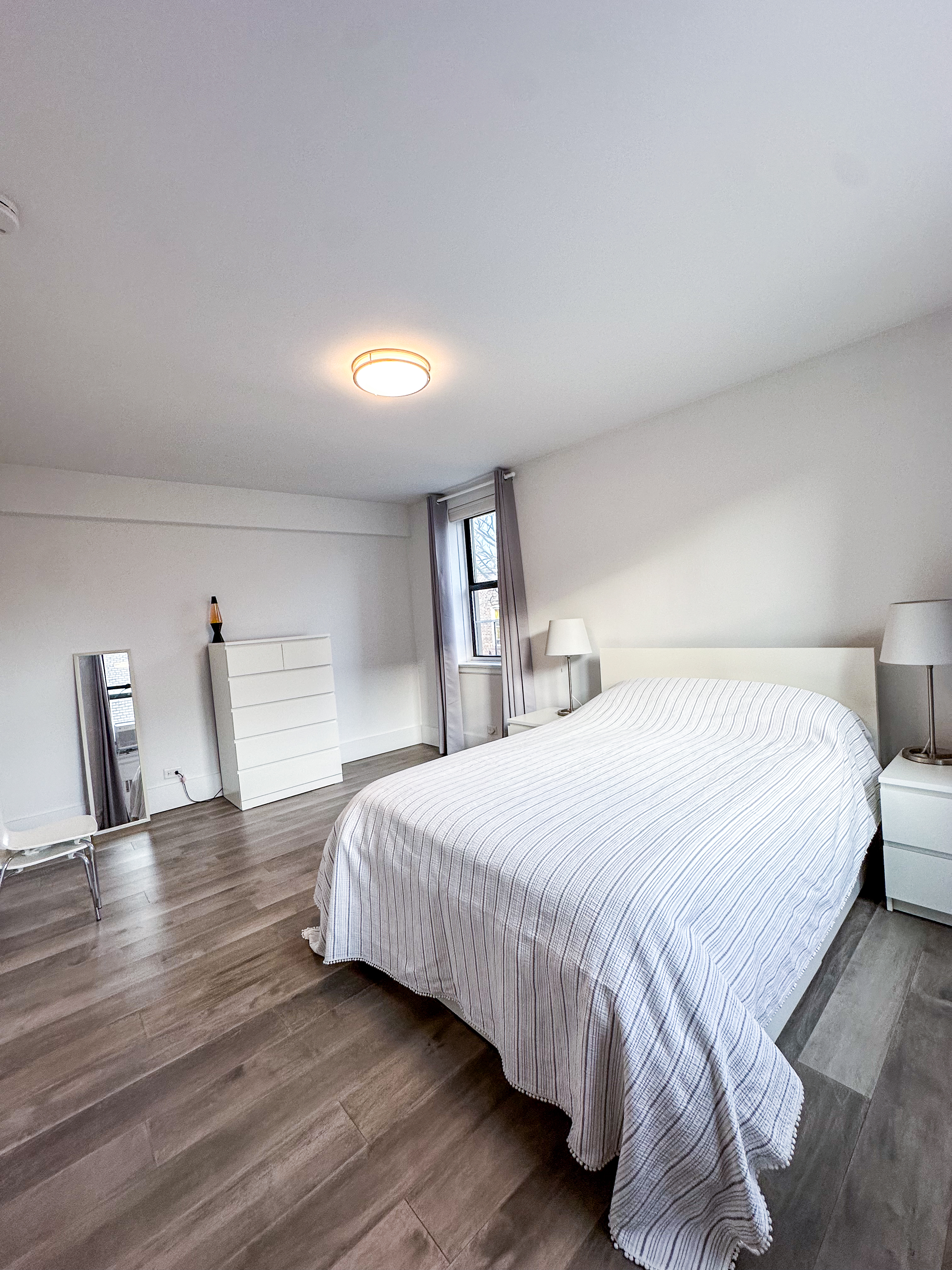 2420 Morris Avenue, Unit 6B Bronx, NY 10468 - Photo 15 of 16 a bedroom with a bed and wooden floor