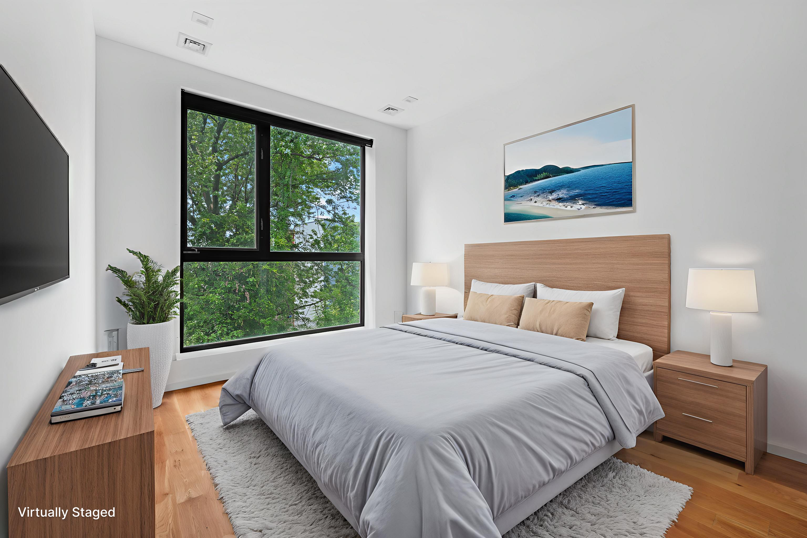 1143 Lafayette Avenue, Unit 4B Brooklyn, NY 11221 - Photo 4 of 9 a bedroom with a bed and a large window