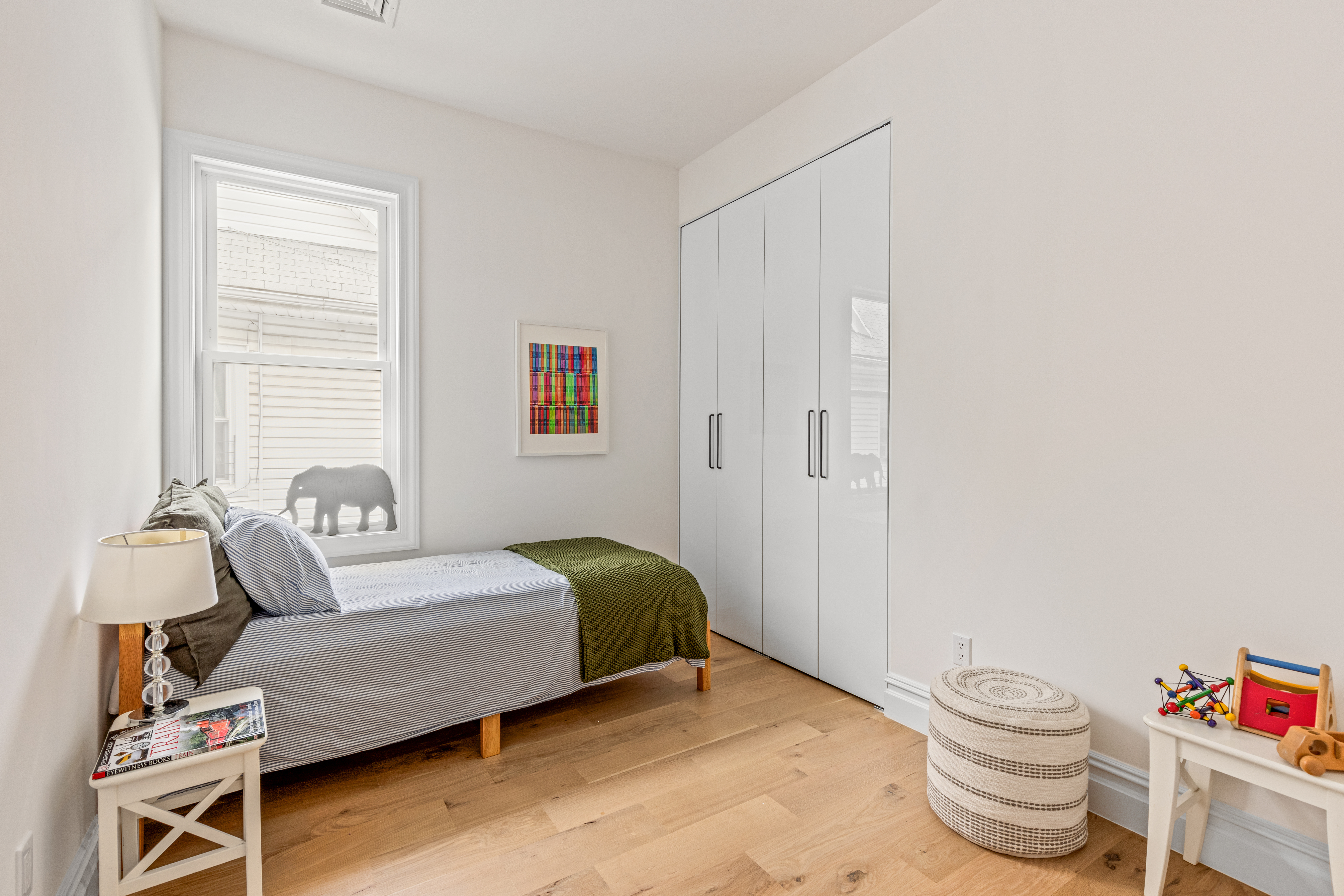 409 East 4th Street Brooklyn, NY 11218 - Photo 8 of 19 a bedroom with a bed and a chair