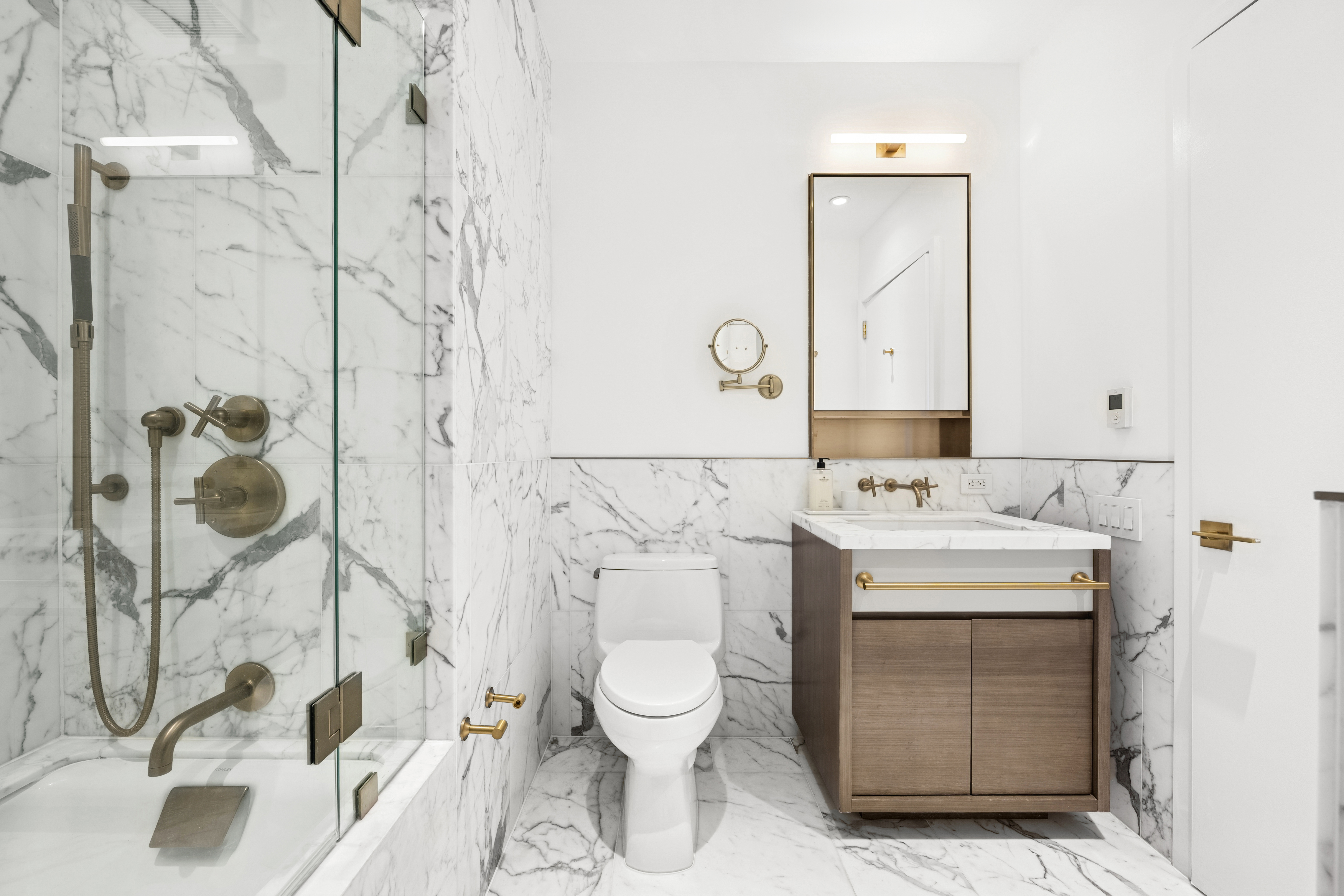 305 East 51st Street, Unit 11D Manhattan, NY 10022 - Photo 9 of 18 a bathroom with a sink toilet and shower