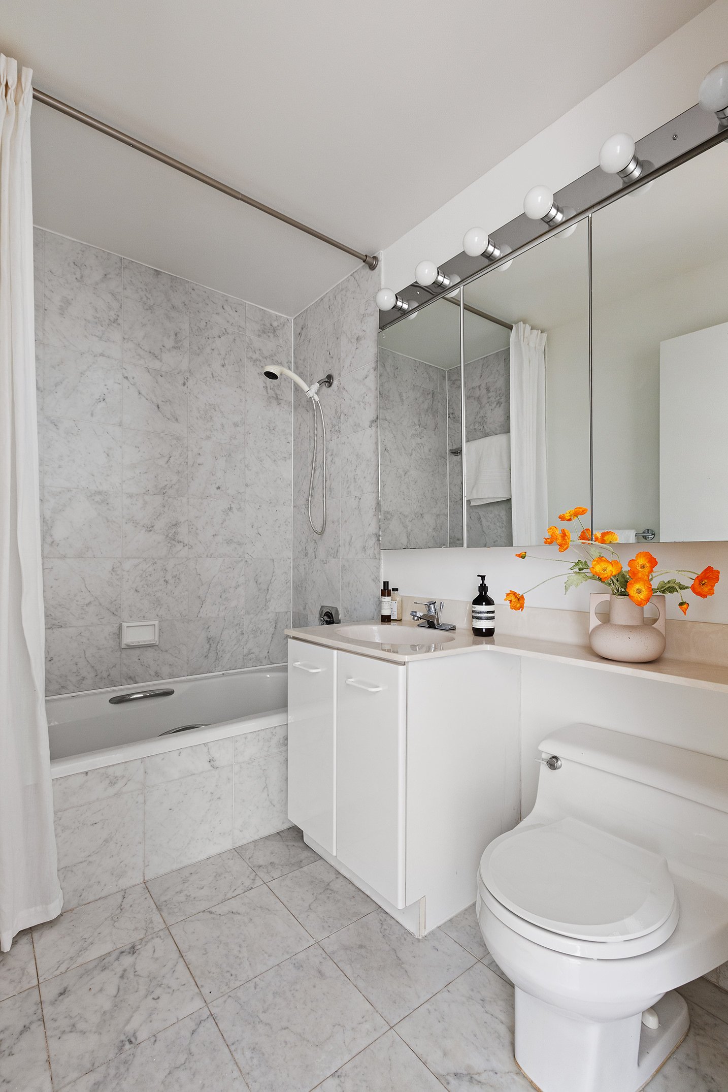 2 South End Avenue, Unit 7B Manhattan, NY 10280 - Photo 8 of 17 a bathroom with a sink mirror toilet and bathtub