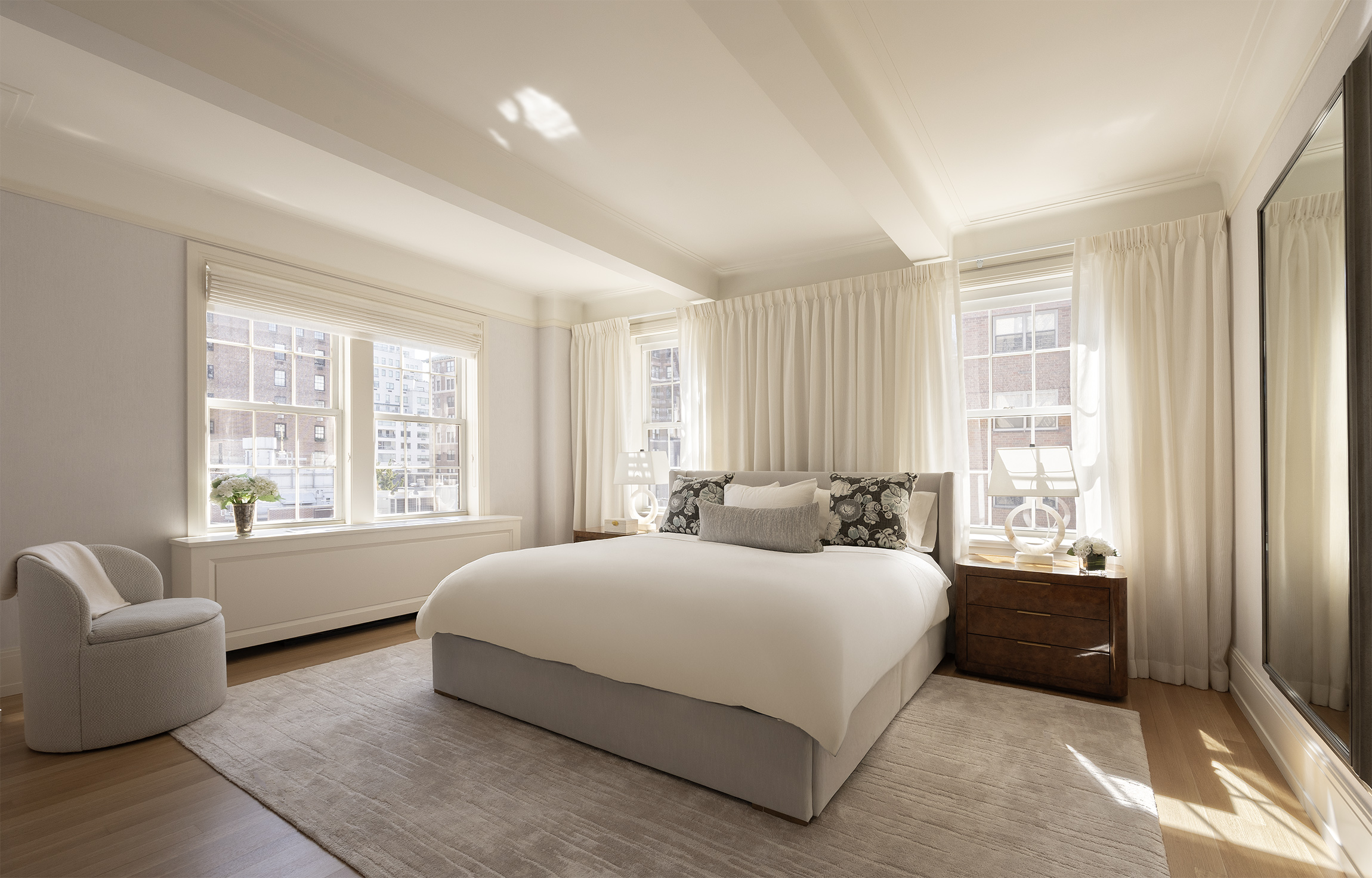 40 East 66th Street, Unit 9A Manhattan, NY 10065 - Photo 7 of 14 a bedroom with a bed and a couch