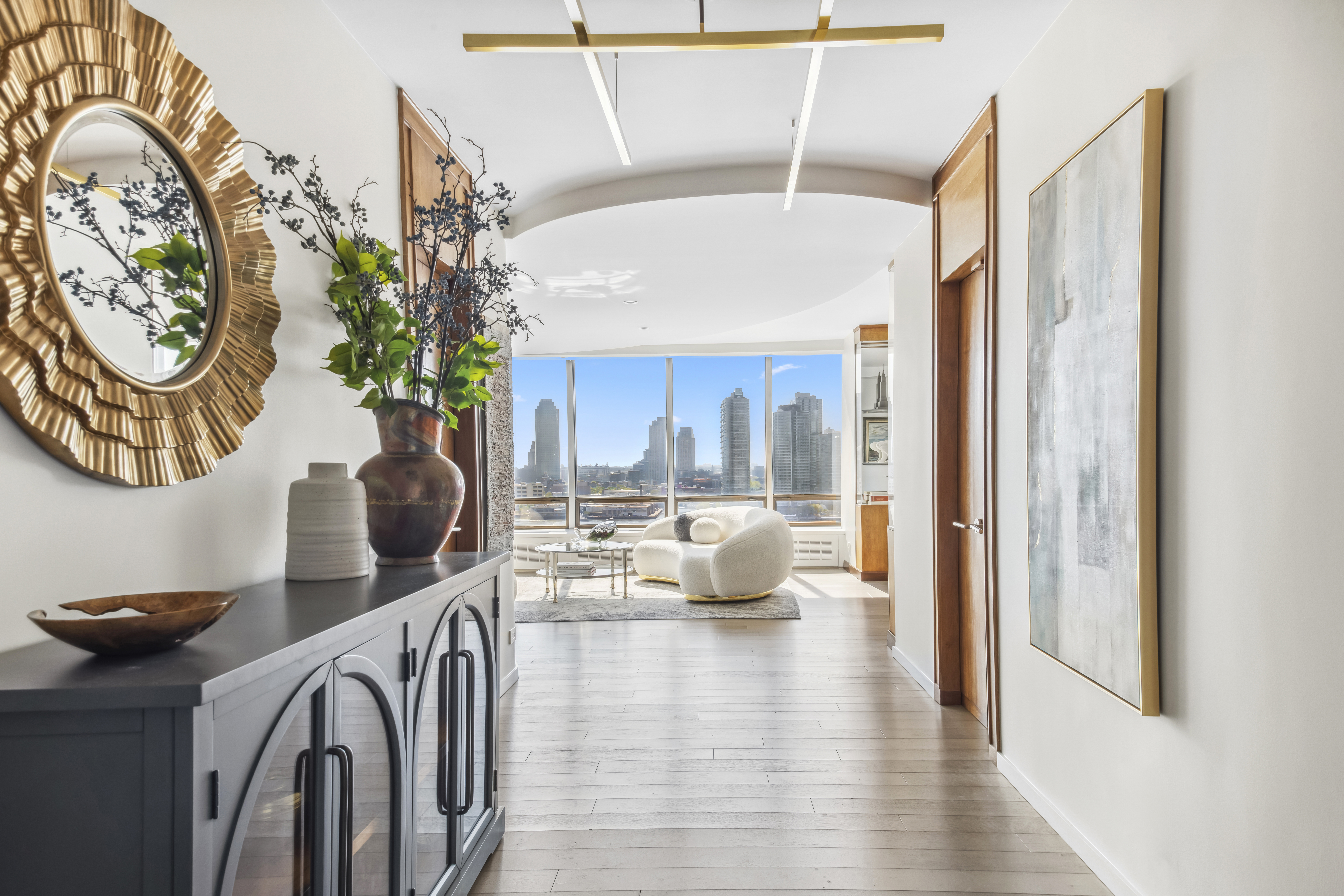 870 United Nations Plaza, Unit 15E Manhattan, NY 10017 - Photo 4 of 19 a living room with furniture and a large window