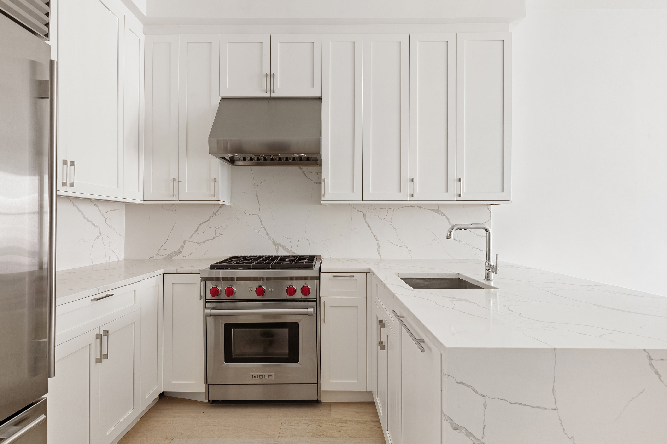 494 7th Street, Unit 3 Brooklyn, NY 11215 - Photo 3 of 9 a kitchen with granite countertop white cabinets and white stove