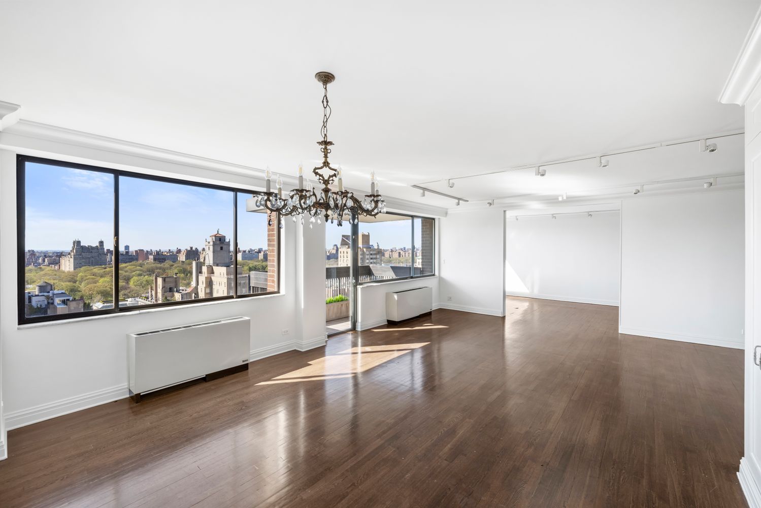 40 East 80th Street, Unit 25A Manhattan, NY 10075 - Photo 4 of 18 a view of a livingroom with furniture wooden floor and a large window