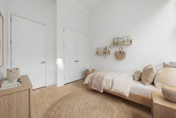 a bedroom with a bed and painting on the wall