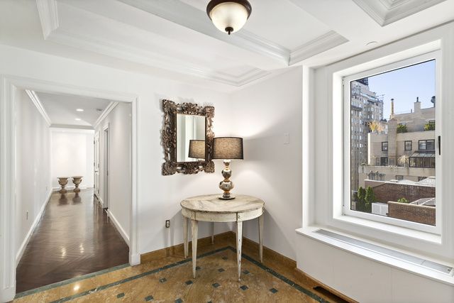 15 East 69th Street, Unit 10D Manhattan, NY 10021 - Photo 5 of 12 a living room with furniture and a window