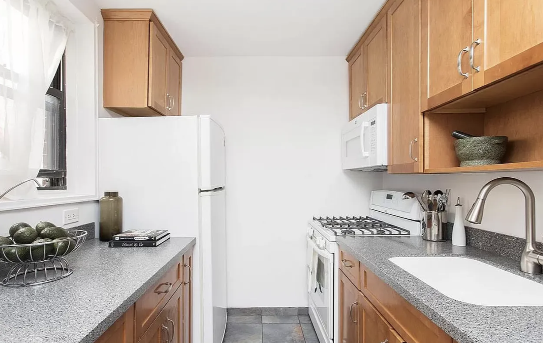 488 Ocean Parkway, Unit 3G Brooklyn, NY 11218 - Photo 4 of 8 a kitchen with stainless steel appliances granite countertop a sink stove and cabinets