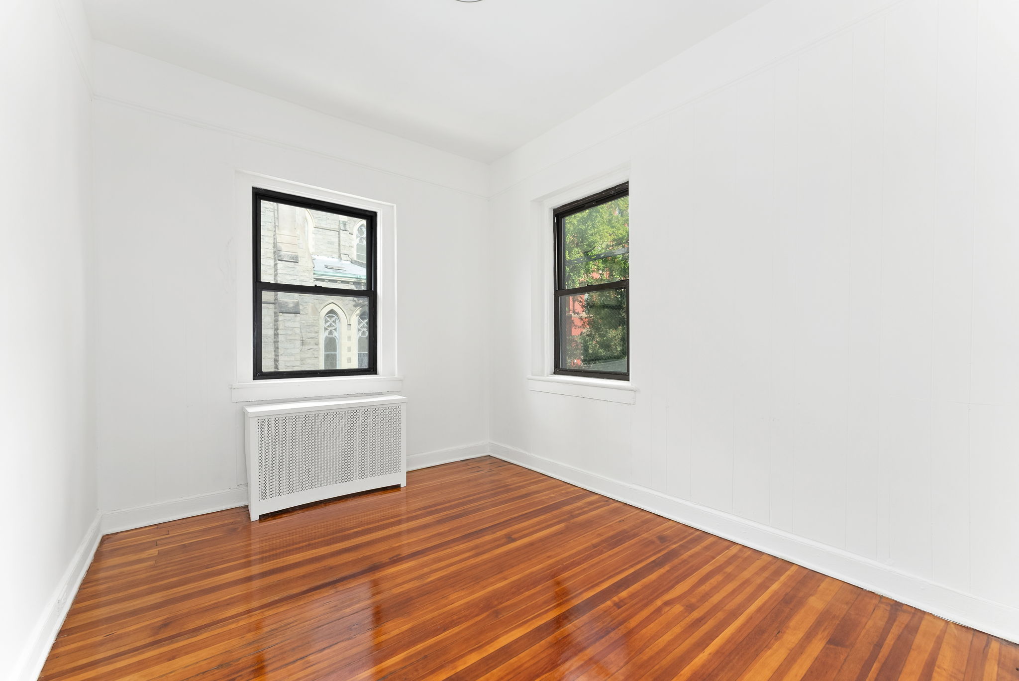 710 Carroll Street Brooklyn, NY 11215 - Photo 3 of 10 a view of empty room with wooden floor and fan