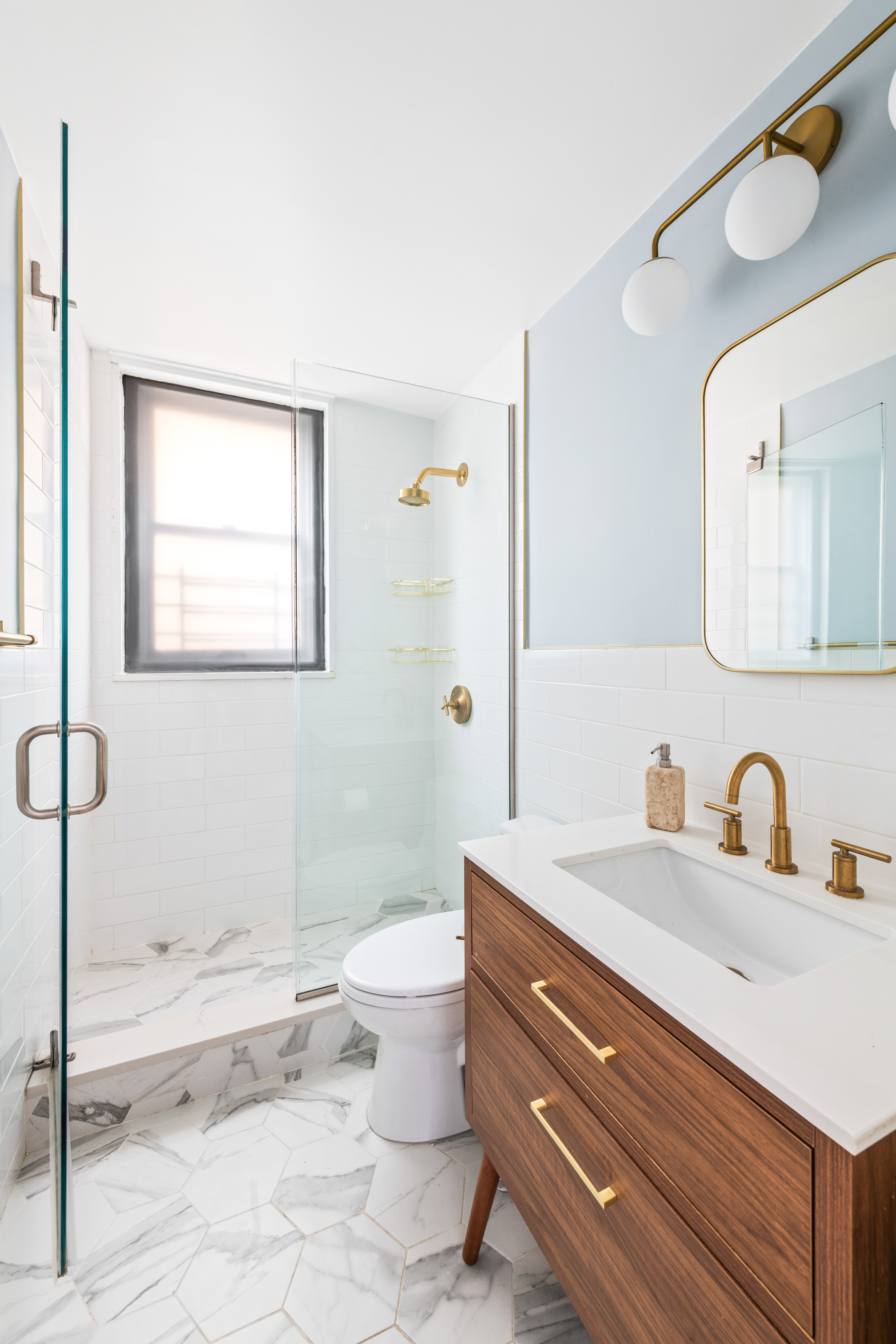 444 East 86th Street, Unit 16B Manhattan, NY 10028 - Photo 10 of 14 a bathroom with a granite countertop sink mirror vanity and toilet