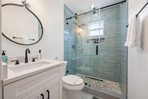 a bathroom with a sink toilet and shower