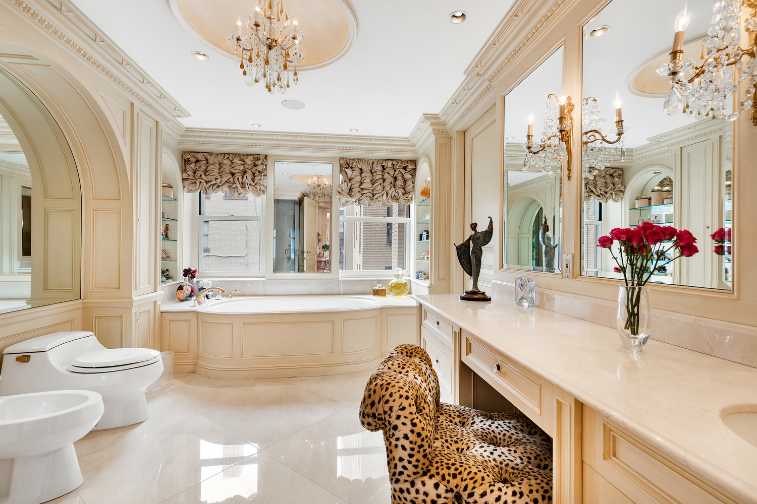 838 5th Avenue, Unit 6 Manhattan, NY 10065 - Photo 16 of 23 a bathroom with a granite countertop sink a toilet a mirror and bathtub