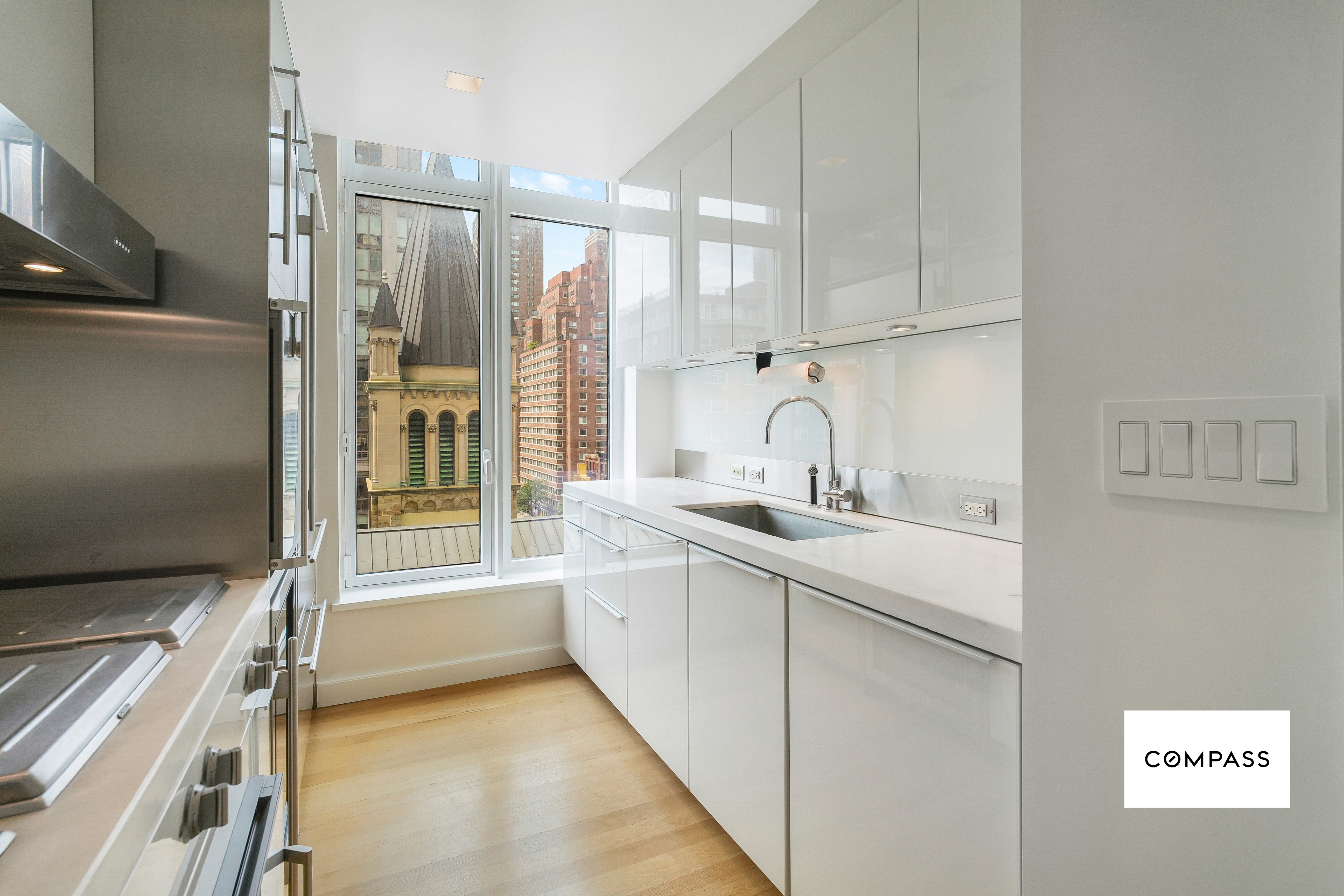 400 East 67th Street, Unit 7B Manhattan, NY 10065 - Photo 2 of 14 a kitchen with a sink and a refrigerator
