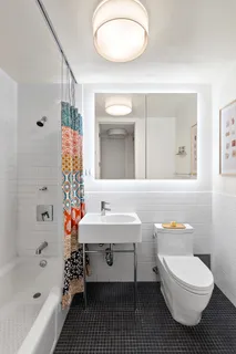 a bathroom with a sink a toilet tub and shower