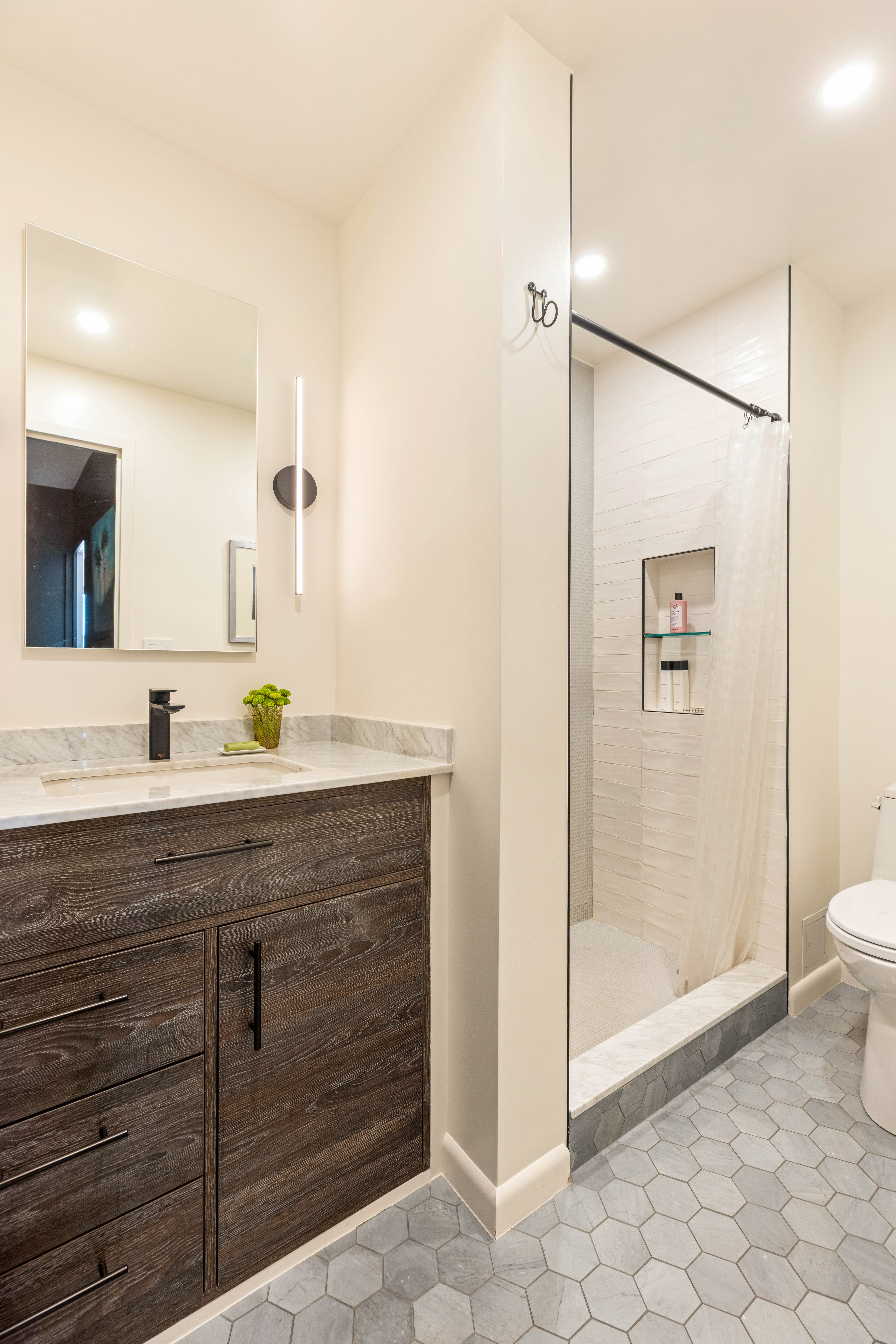 60 East 8th Street, Unit 30F Manhattan, NY 10003 - Photo 6 of 11 a bathroom with a shower sink and mirror