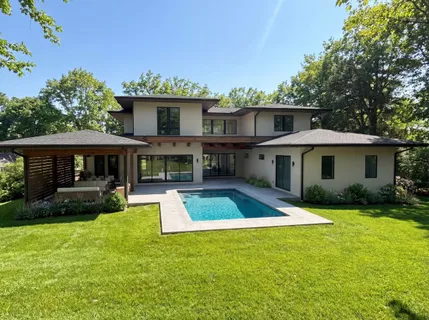 a view of a house with a yard and furniture