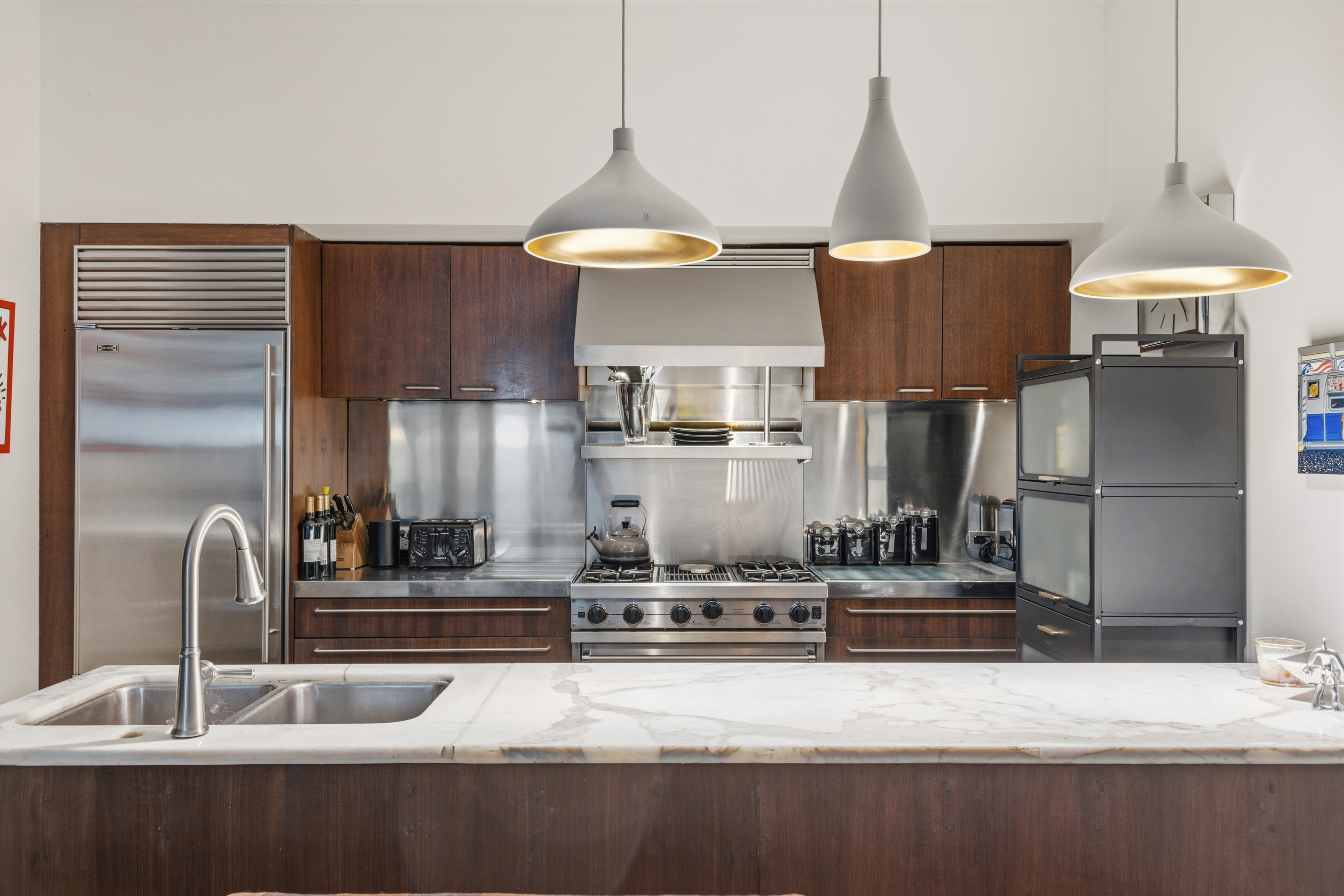 150 Nassau Street, Unit 2A Manhattan, NY 10038 - Photo 4 of 24 a kitchen with stainless steel appliances granite countertop a sink a stove and a refrigerator