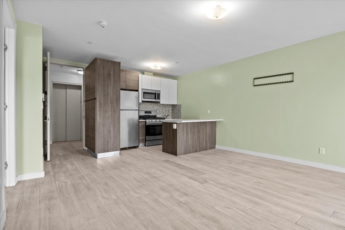 1972 Ocean Avenue, Unit 4A Brooklyn, NY 11230 - Photo 9 of 18 a view of kitchen with wooden floor electronic appliances and window