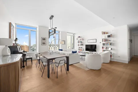 a living room with furniture a dining table and a fireplace