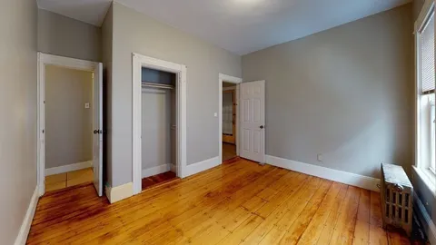a view of an empty room and wooden floor