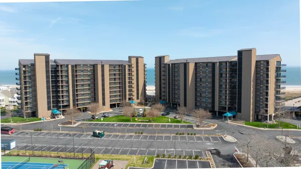 a view of residential houses with outdoor space and lake view