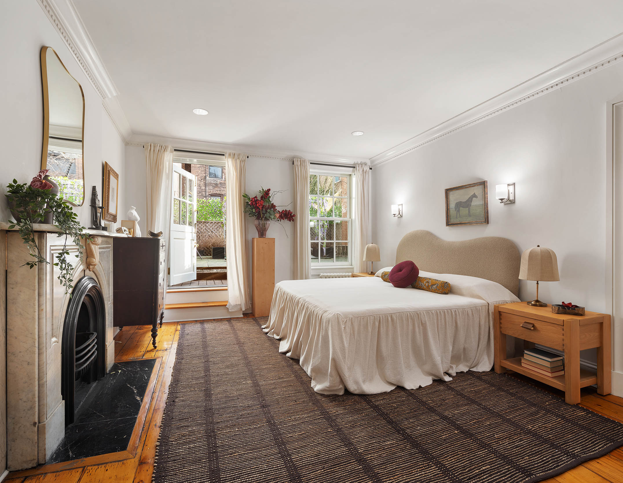 313 West 20th Street Manhattan, NY 10011 - Photo 10 of 20 a bedroom with a bed a fireplace and a large window