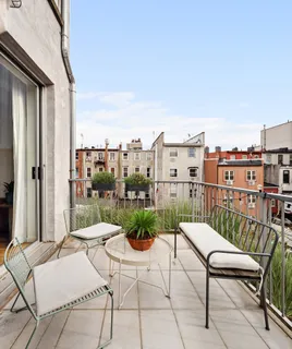 a view of a balcony with furniture