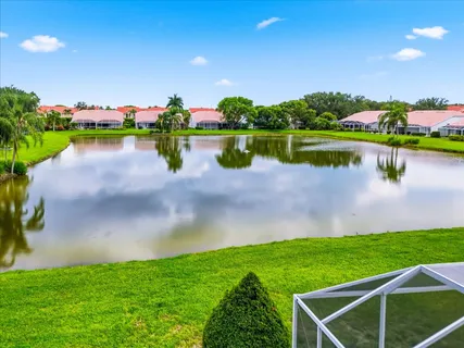 a view of a lake with houses in the back
