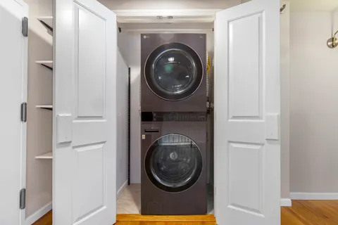 a view of a hallway with washer and dryer