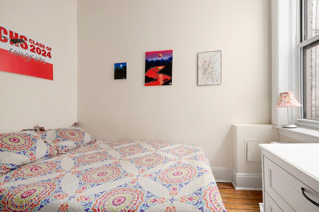 a bedroom with a bed and a dresser