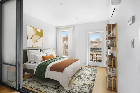 a bedroom with a large bed and a window