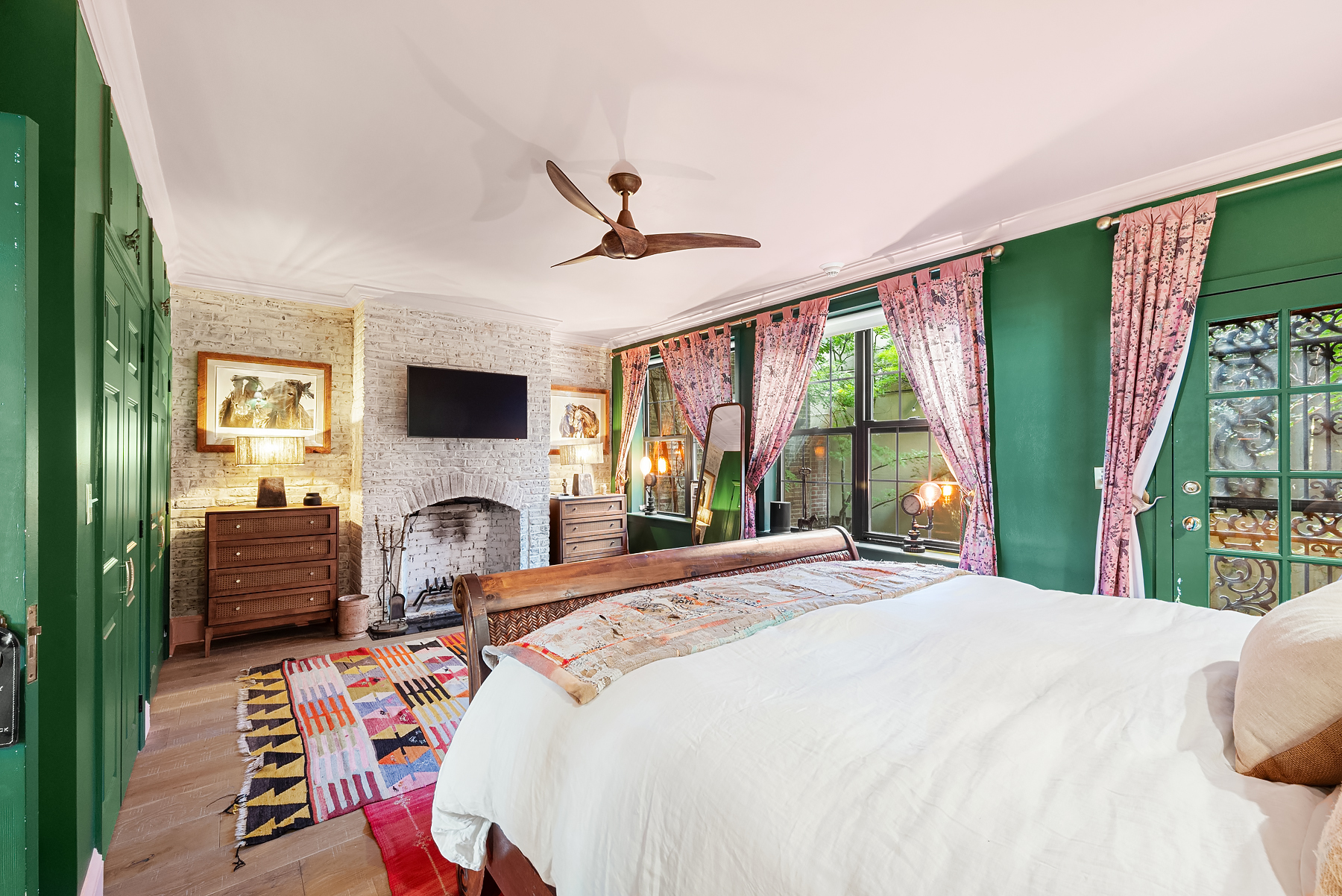 57 Sullivan Street, Unit DUPLEX Manhattan, NY 10012 - Photo 2 of 9 a bedroom with a bed couch tv and a large window