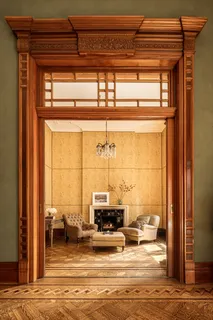 a view of a living room with a floor to ceiling window and wooden floor