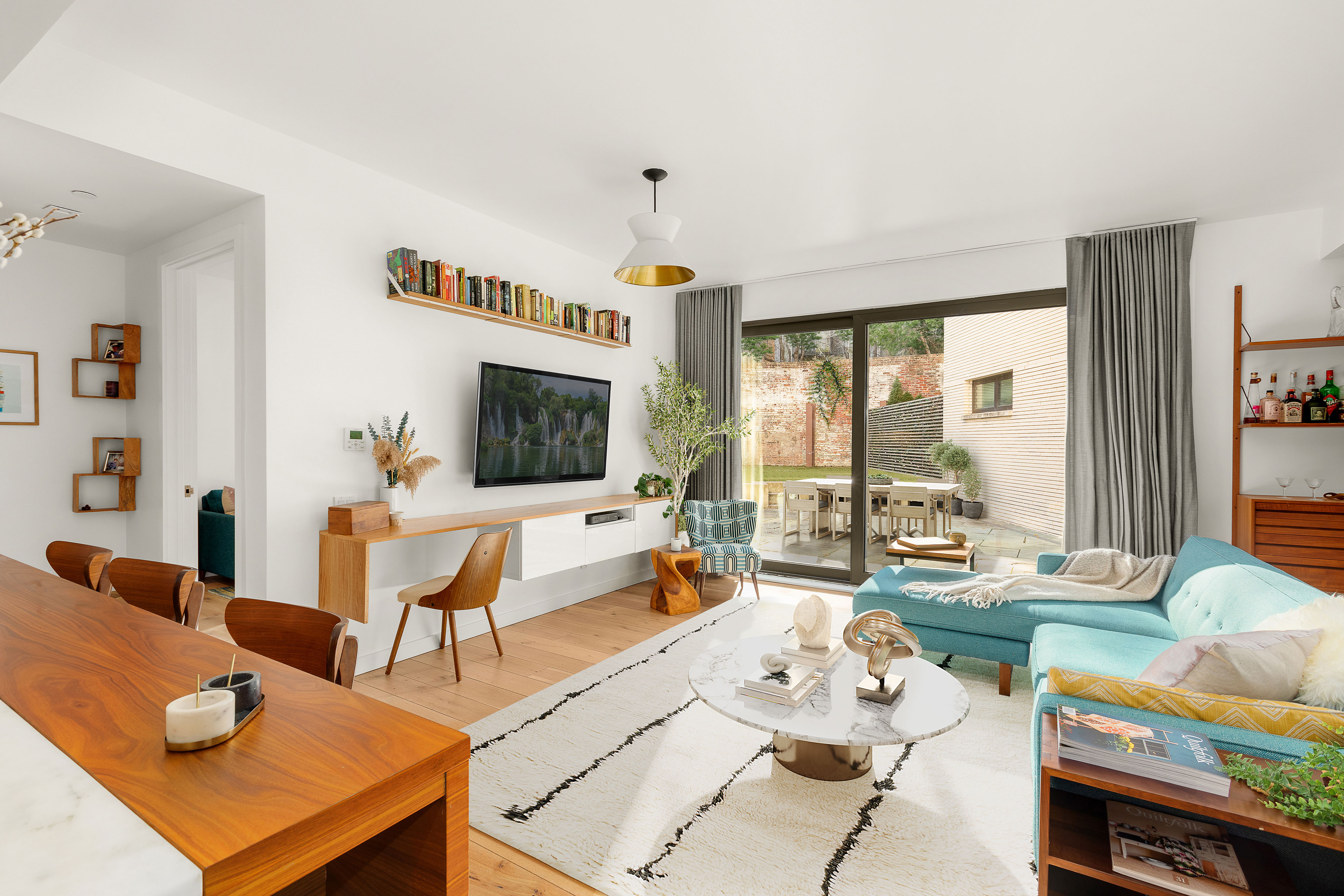 280 Saint Marks Avenue, Unit TH-E Brooklyn, NY 11238 - Photo 2 of 10 a living room with furniture and a flat screen tv