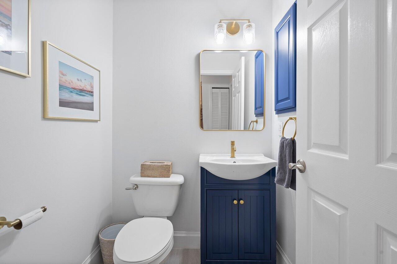 1182 Canoe Point Delray Beach, FL 33444 - Photo 19 of 46 a bathroom with a toilet sink and mirror